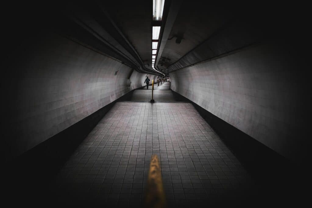 a person walking down a long hallway in a building