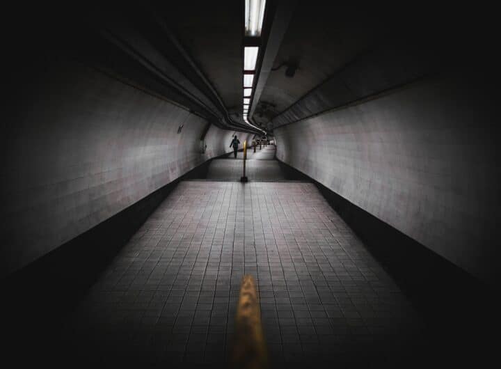 a person walking down a long hallway in a building