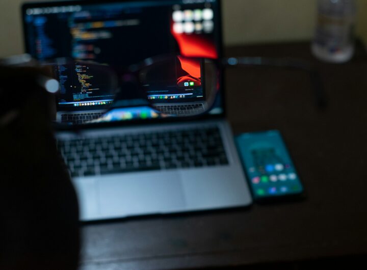 macbook pro beside black remote control